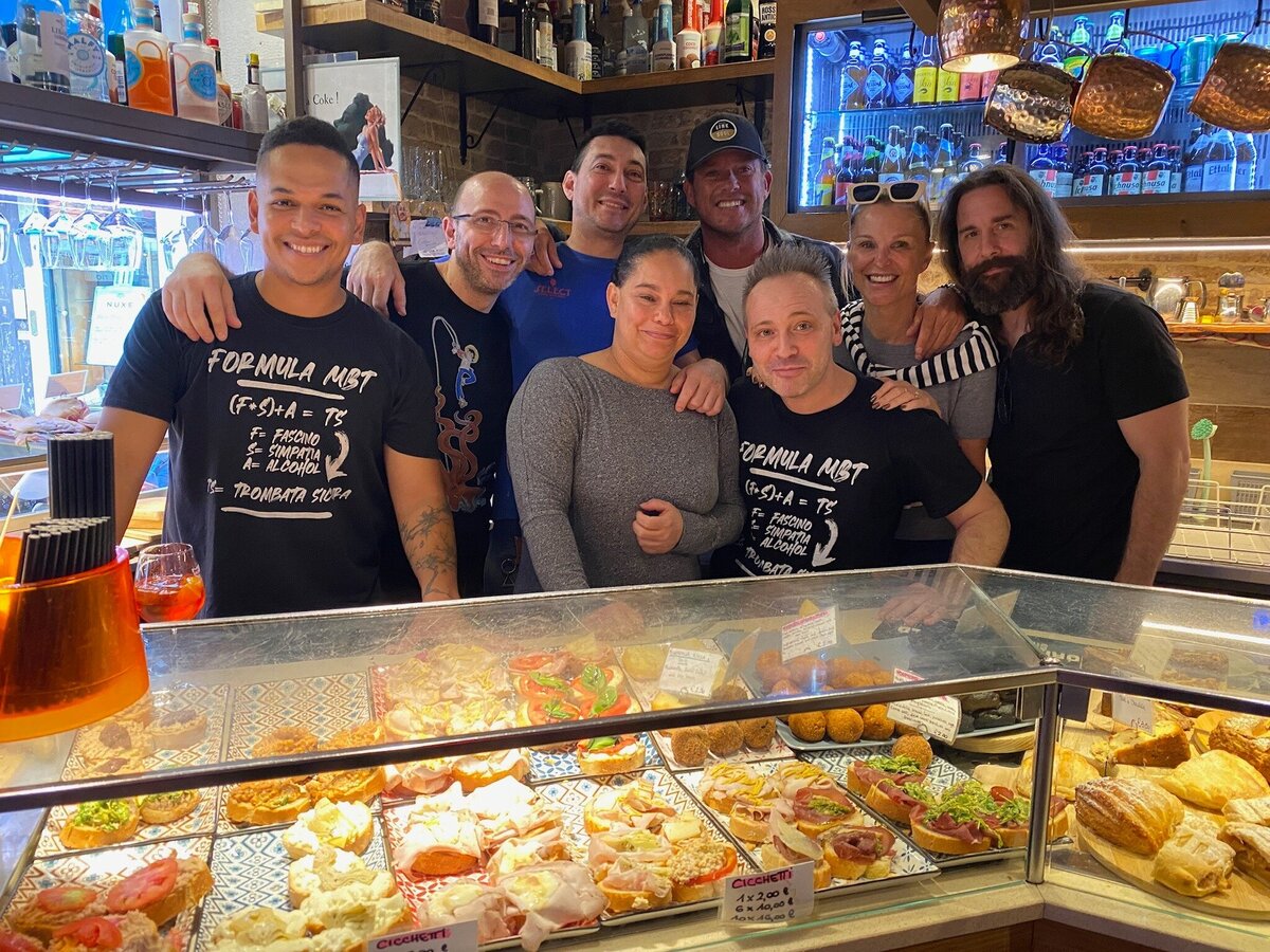 Owners and employees of Venetian bacaro Magna Bevi Tasi in Venice's Castello gather behind bar.