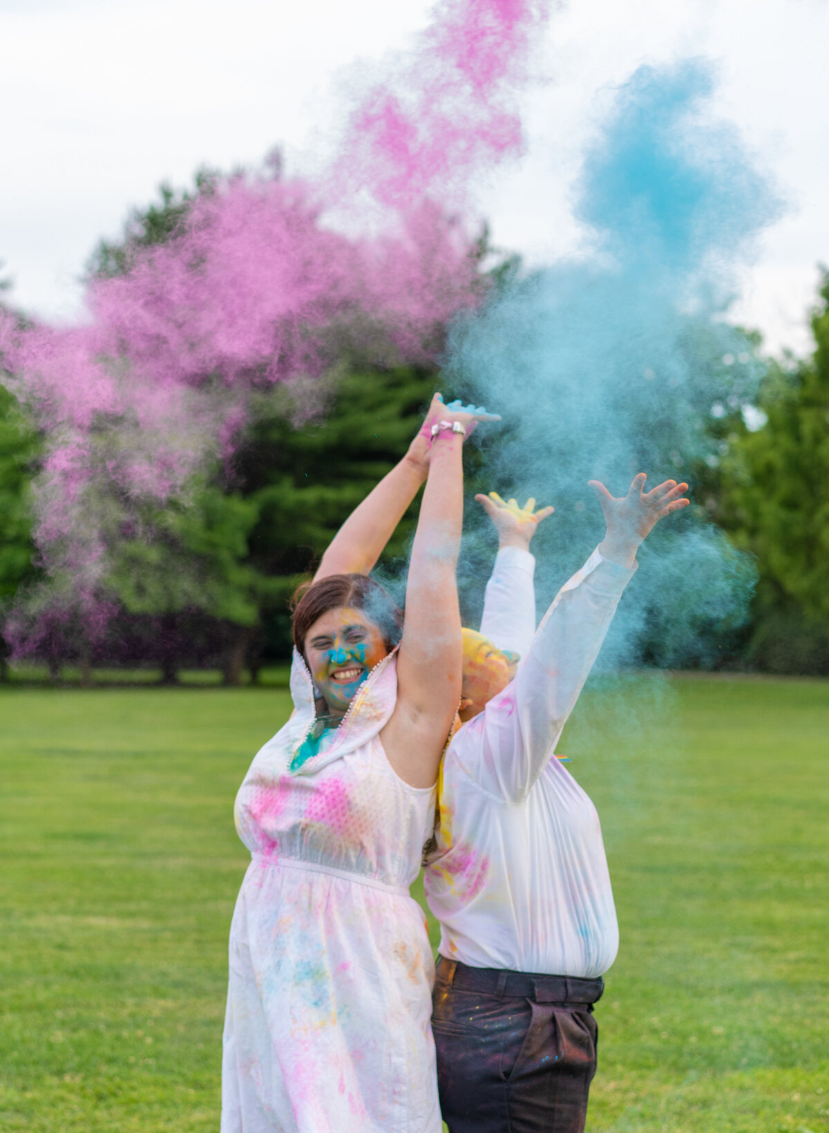 Ivalee and her fiancee, Kara, throwing up colored powder at the Columbus Park of Roses.