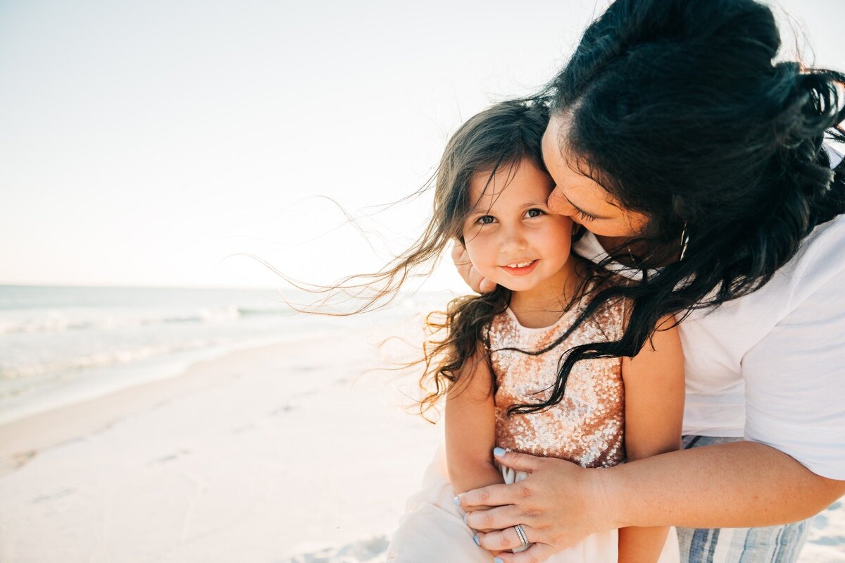 mom kissing daughter at Pensacola Beach
