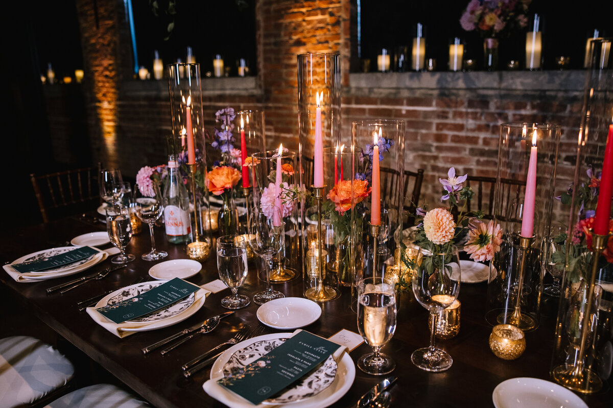 Wedding table setting by DiAnoia's Eatery with candles and flowers by The Farmer's Daughter florist, at the Pittsburgh Opera. 