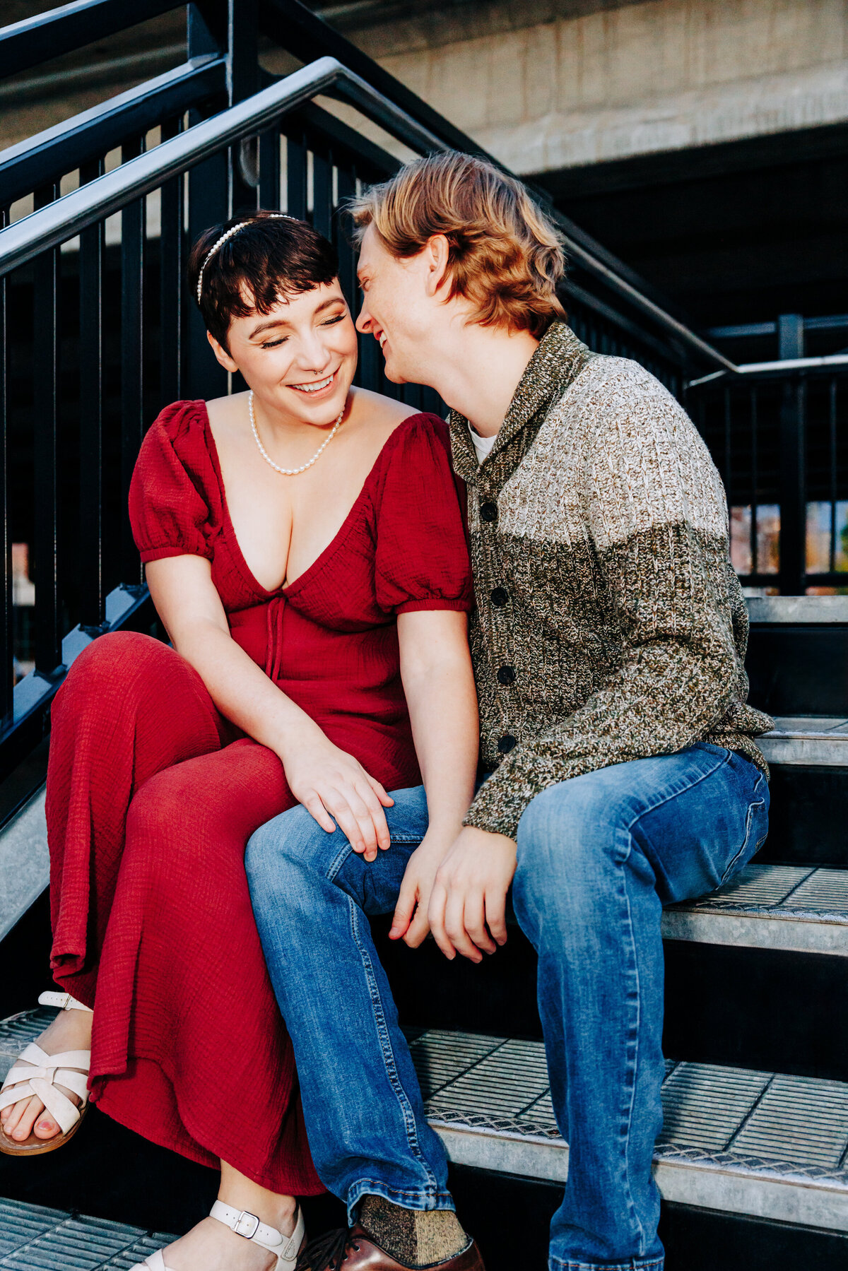 Engaged couple funny moment on staircase at Cara Park in Missoula