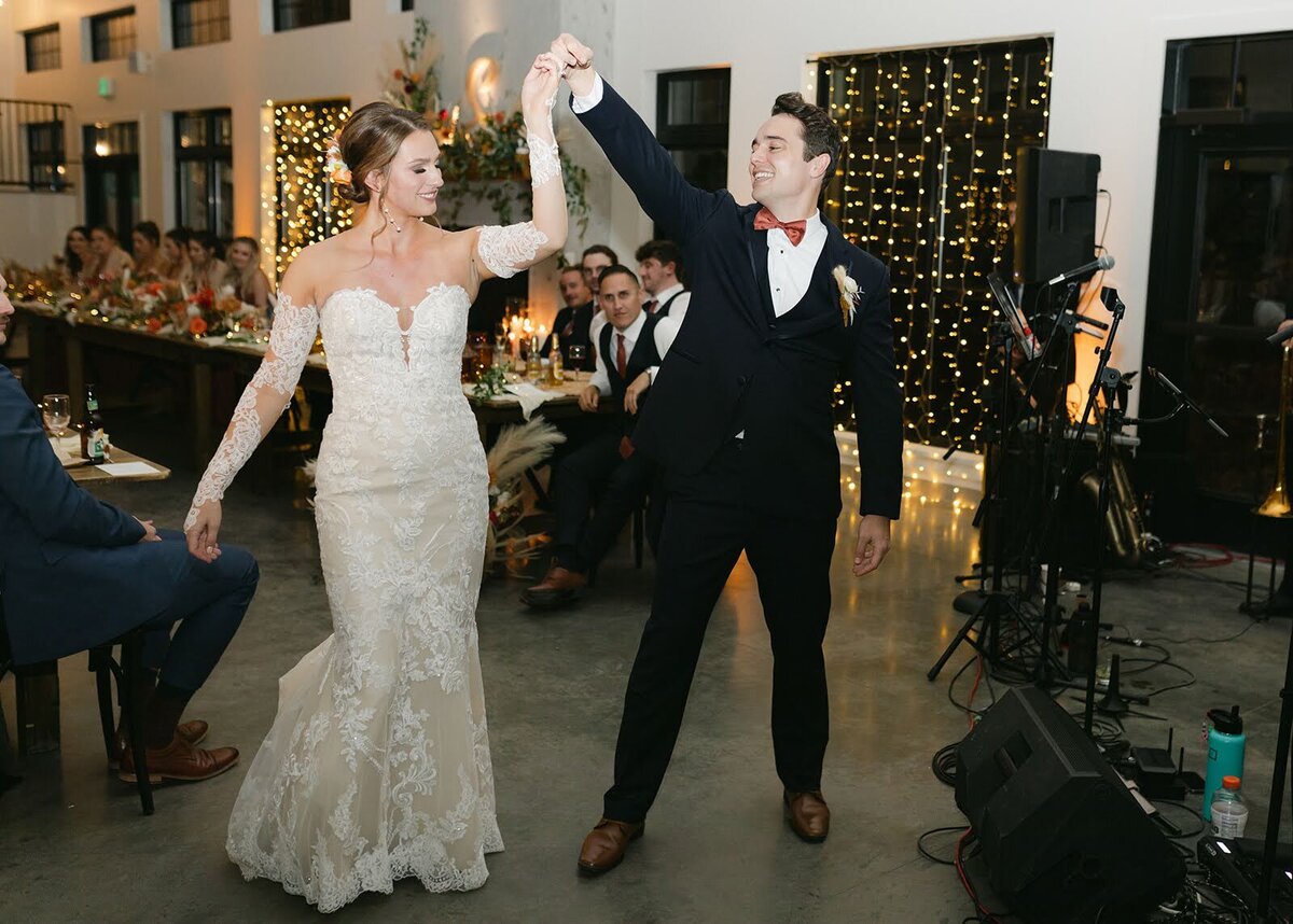 Bride and Groom share a spin in their first dance with a live band at North Star Gatherings.