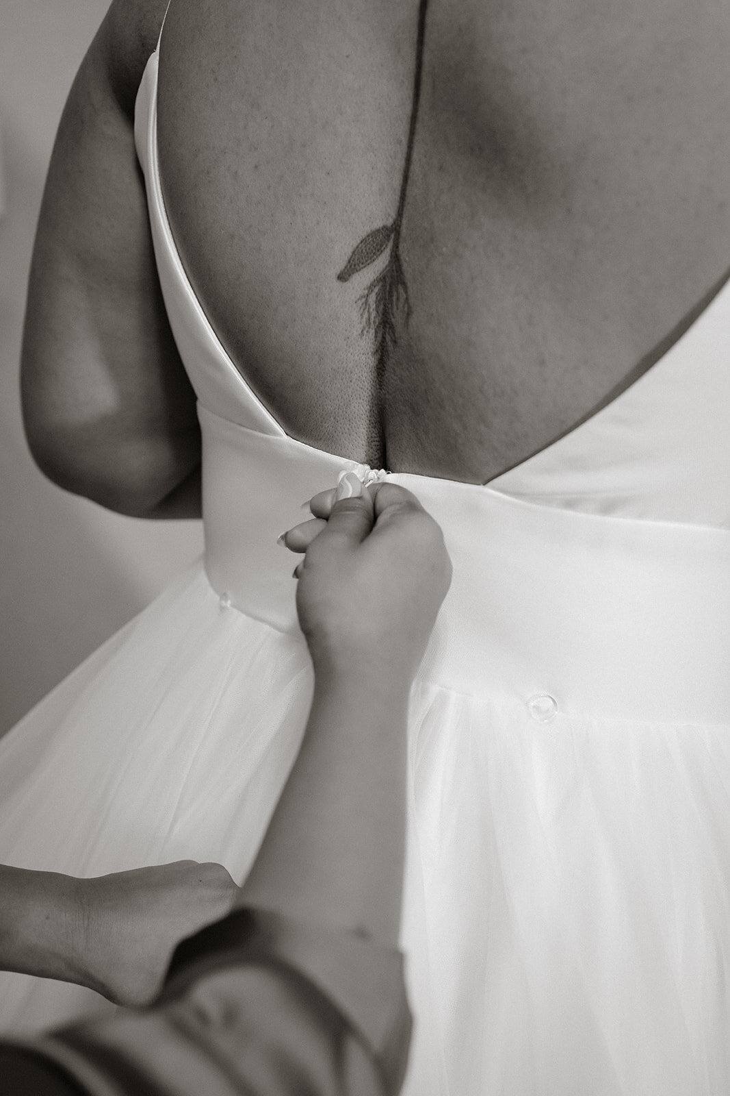 zipping up wedding dress