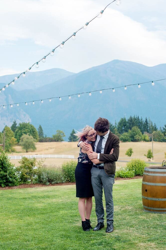 crystal genes photography and her boyfriend hug during a wedding at wind mountain ranch