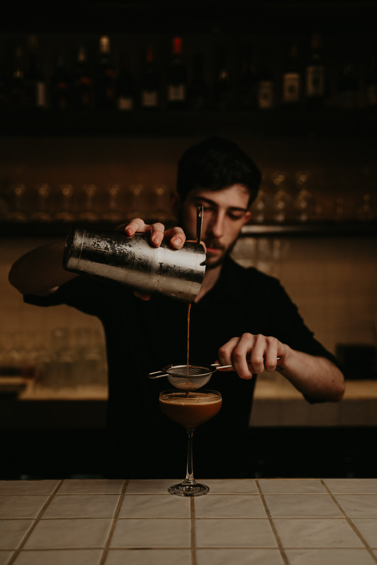 cocktail maker making an espresso martini .