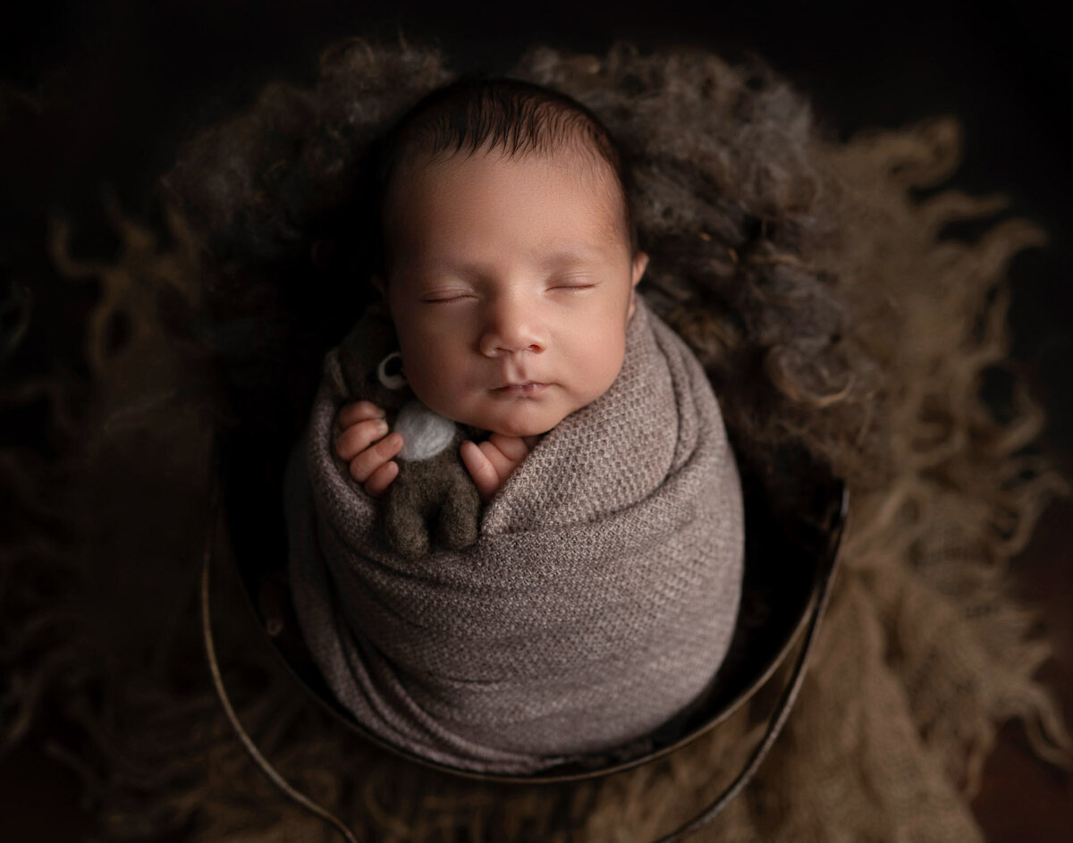 Newborn baby wrapped in bowl pose Liberty Hill professional photographer