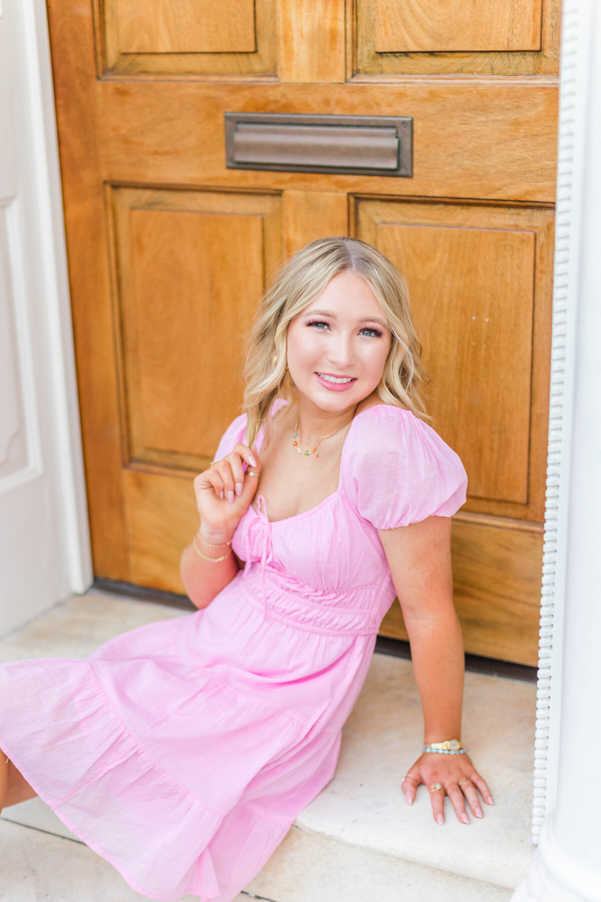 blonde-headed senior in pink dress