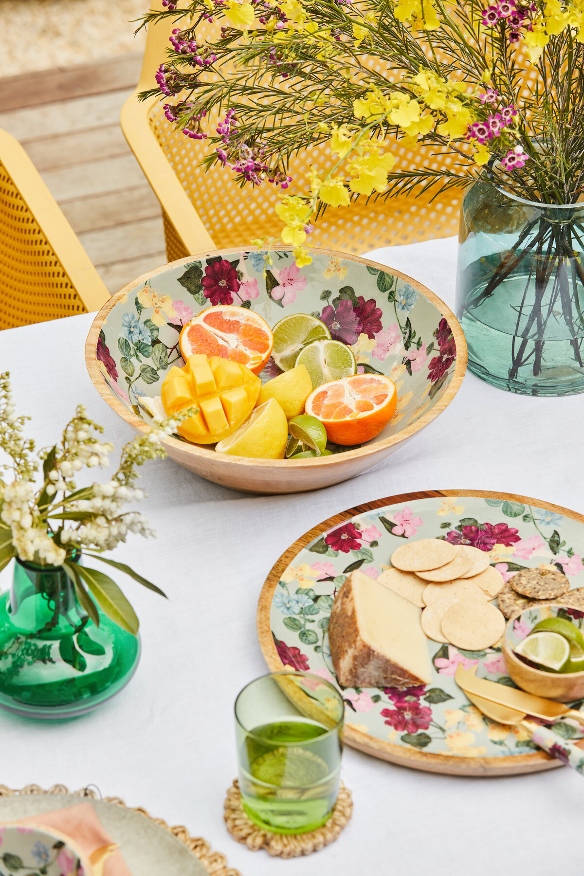 Outdoor dining table styled with citrus fruits, floral bowls and native flowers in Melbourne home
