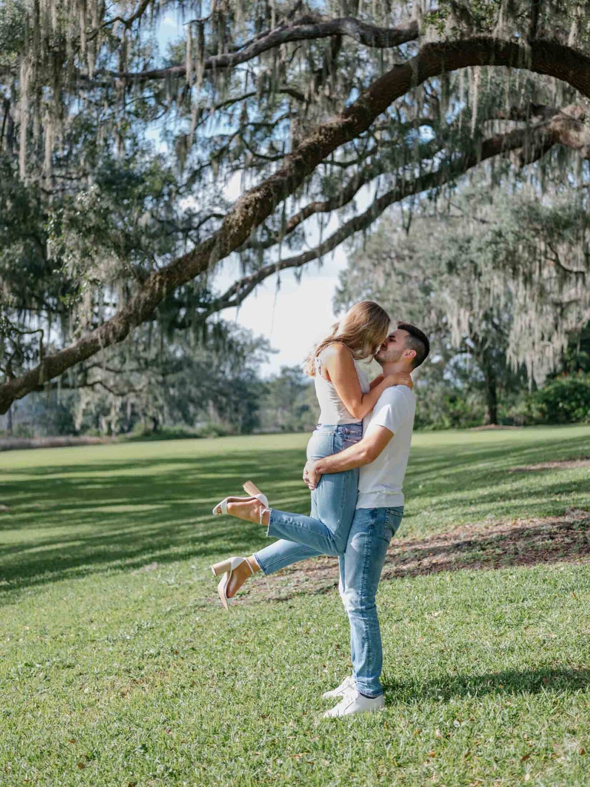 Charleston inspired engagement session in Florida underneath Spanish moss trees.