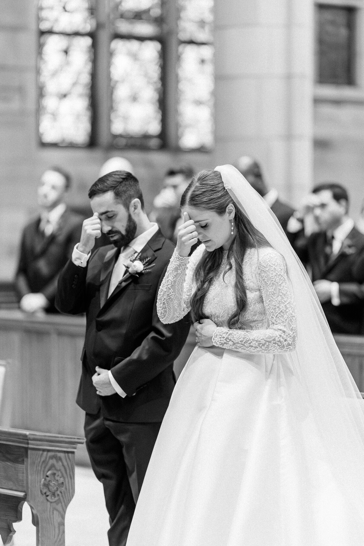 Bride and groom signing the Cross during Our Lady Sorrows Church wedding