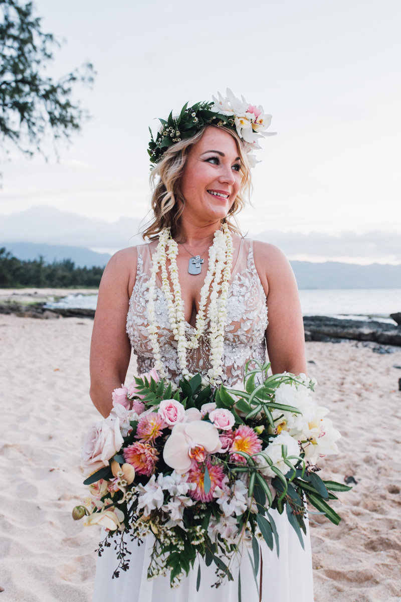 Bride with large boho bouquet and haku lei  on the beach