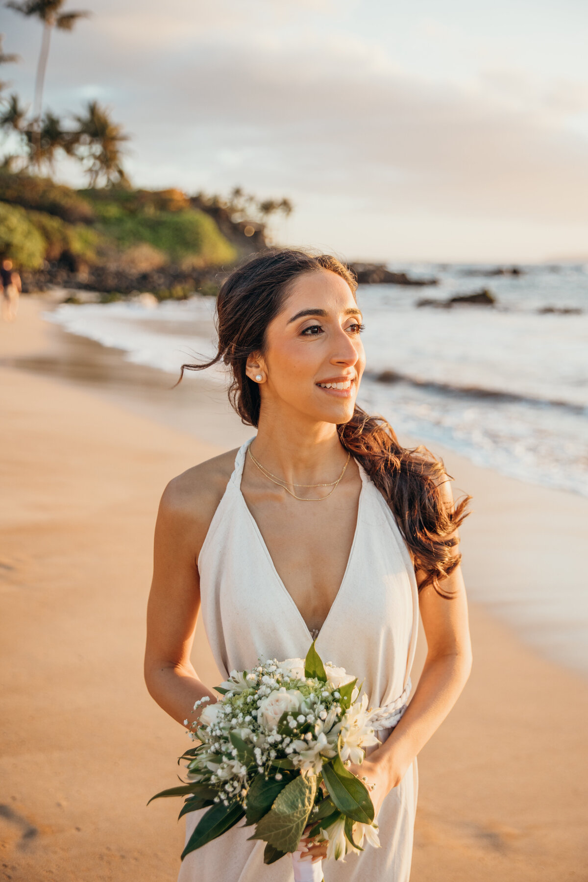 Maui Wedding Photographer captures bride wearing classic wedding gown and holding bridal bouquet