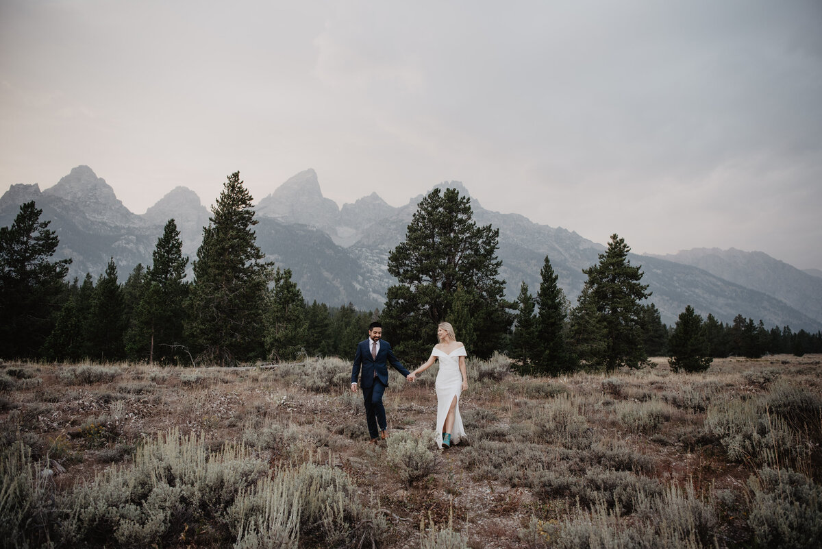 Photographers Jackson Hole capture bride and groom walking in Grand Teton Park