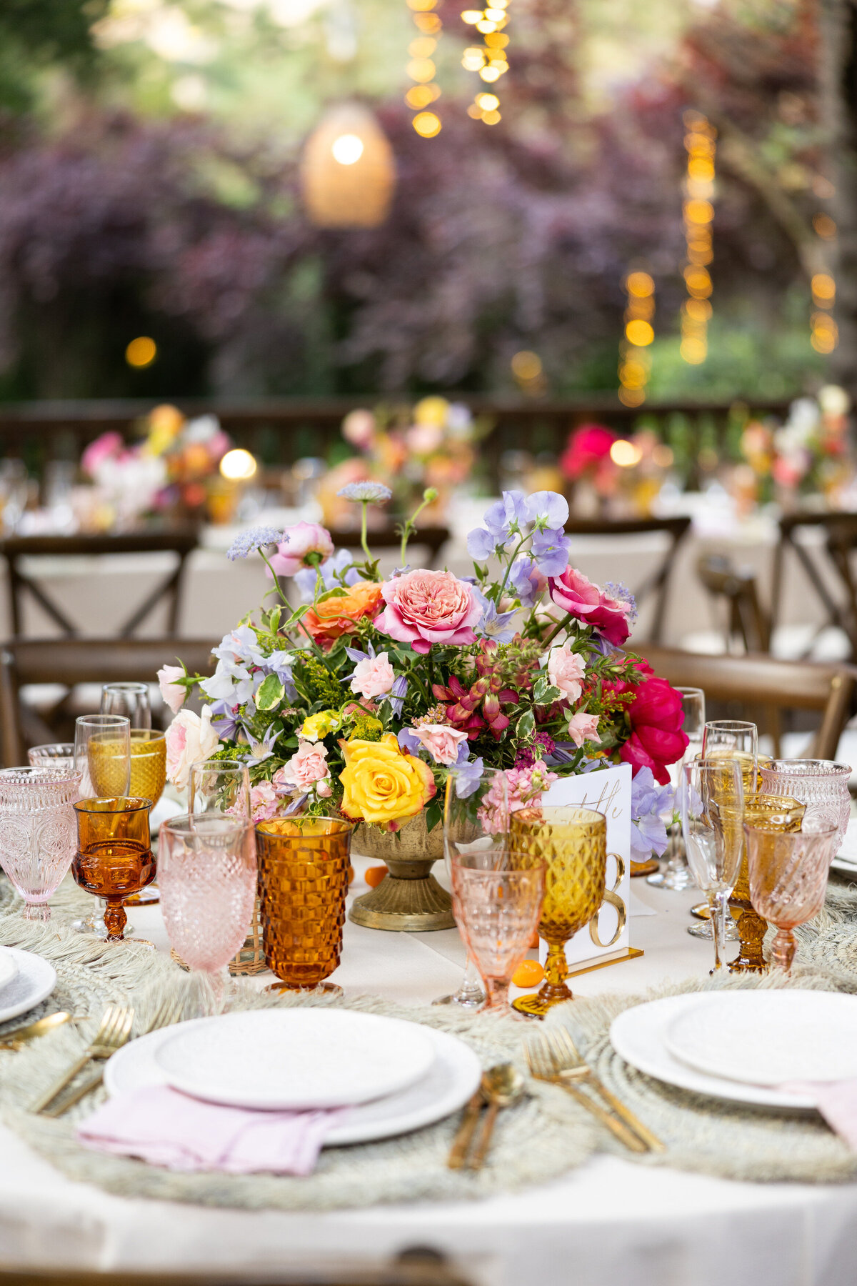 A bouquet of flowers in the middle of a wedding reception table