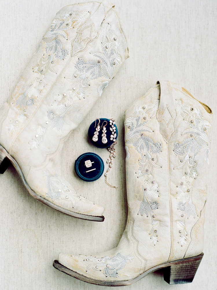 Bride's white cowboy boots and jewelry for a horse ranch wedding in Colorado
