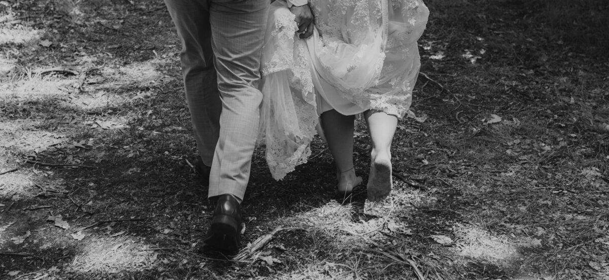 Bride and groom walk hand-in-hand, candid wedding moment in Indiana.