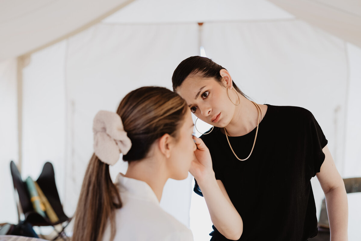 Utah elopement photographer captures makeup artist doing woman's makeup