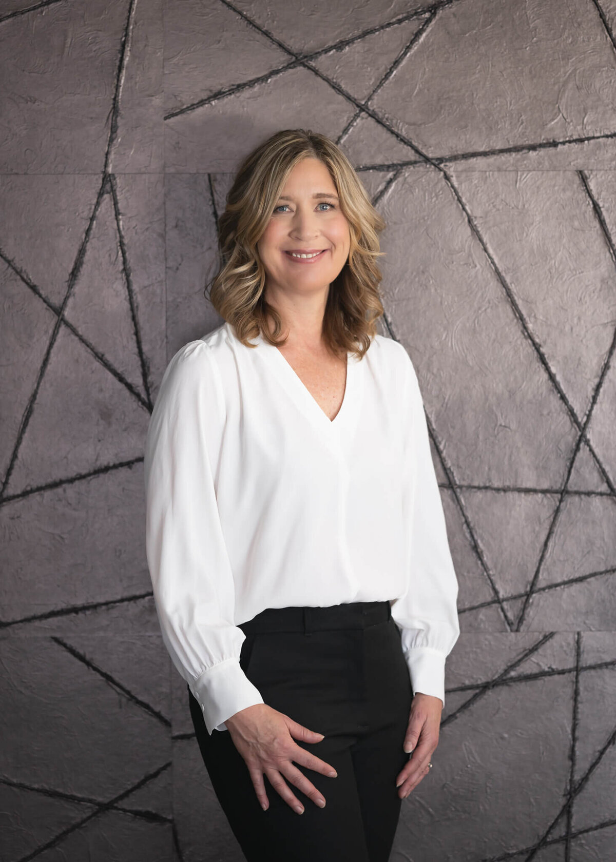 environmental portrait headshot  of practitioner in cream shirt with geometric background