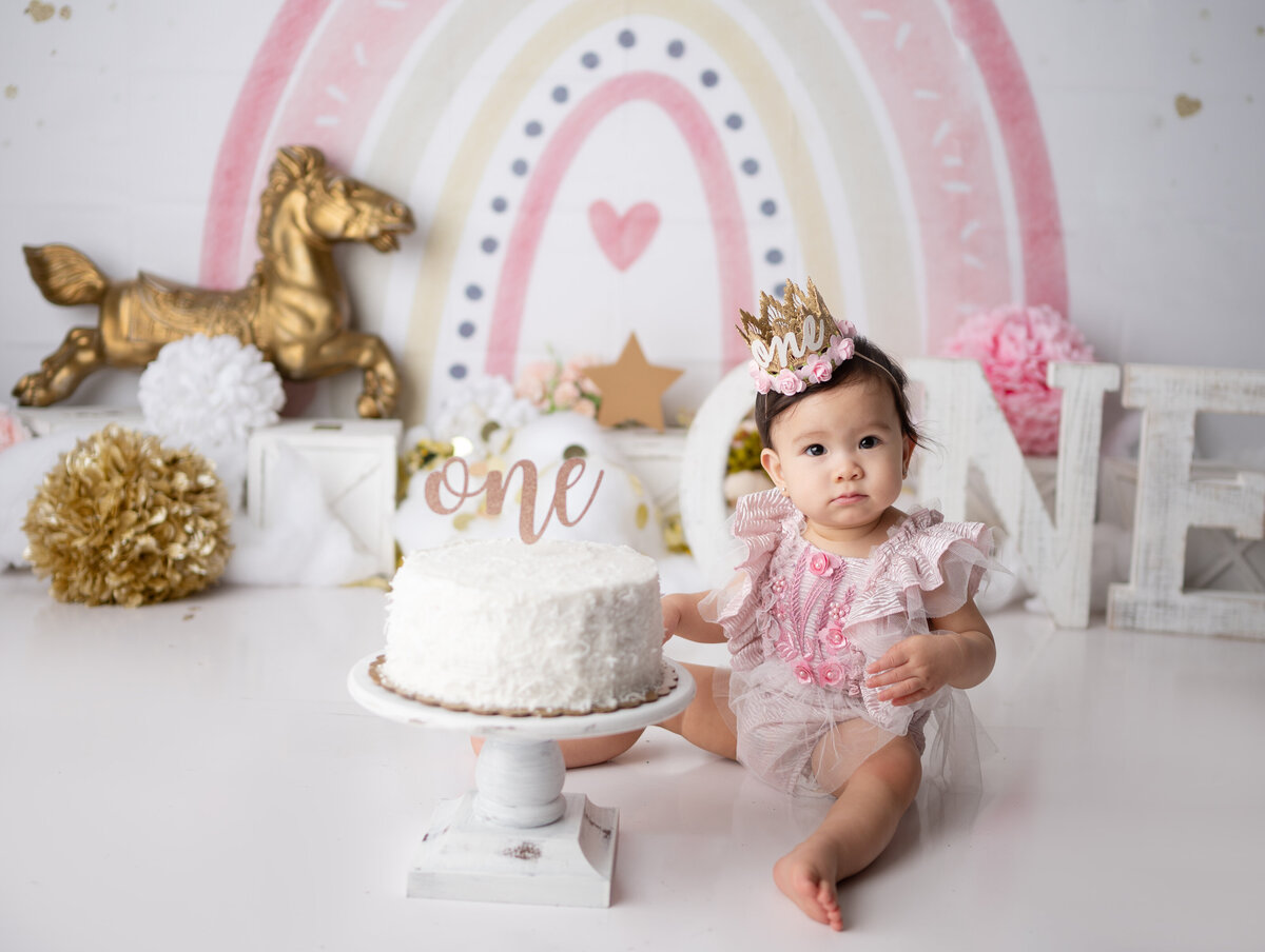 one year pink and gold rainbow cake smash