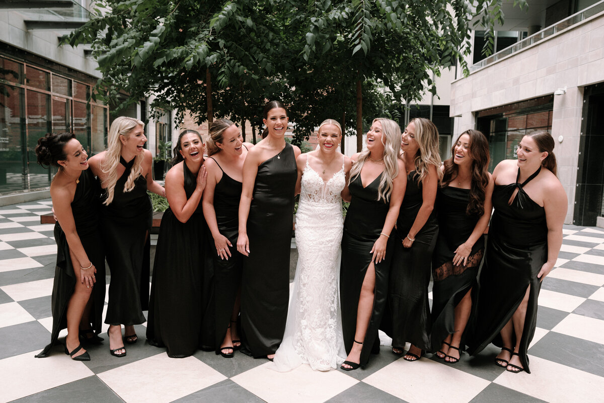 Bridal party having a big laugh as they are so happy for their friend who has gotten married