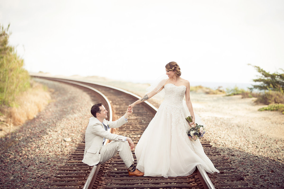 Seagrove Park wedding photos fun couple on train tracks