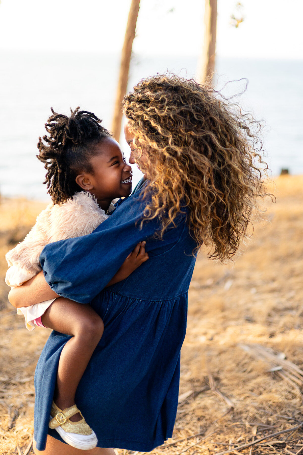 Mother holding daughter smiling nose-to-nose outdoors, Bay Area Family Portfolio – Ellobelle Photography