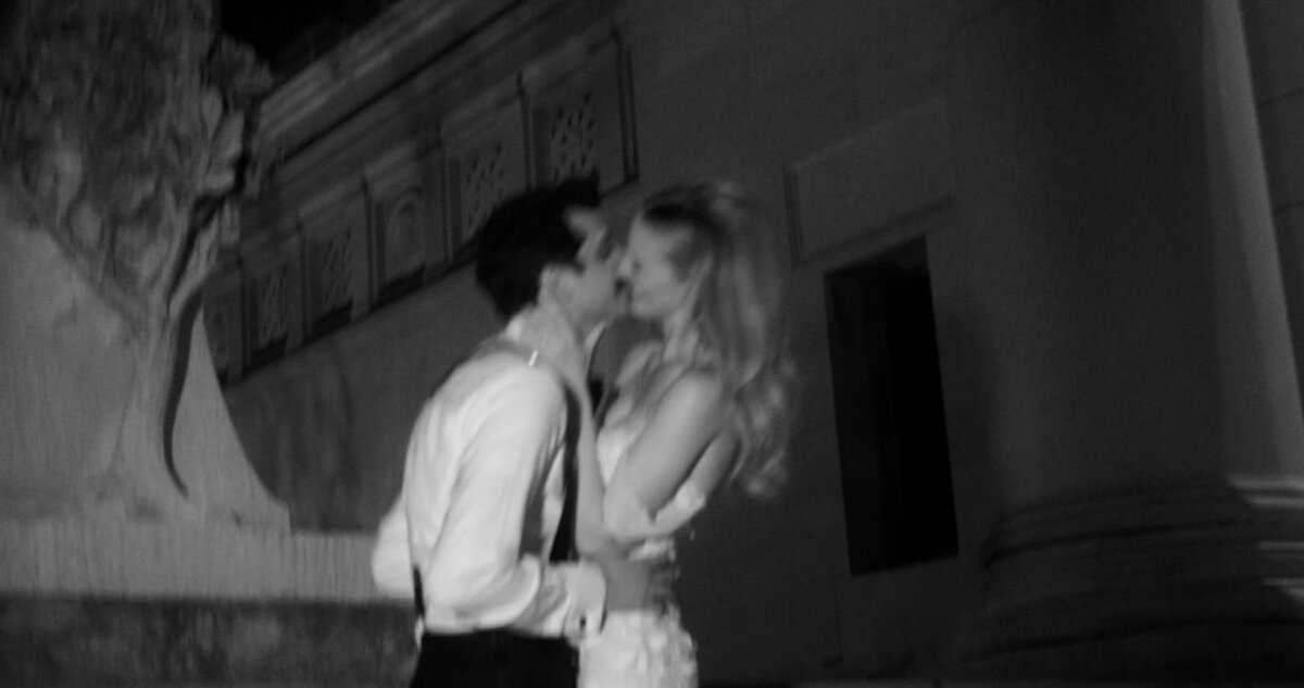 blurry black and white of bride and groom kissing