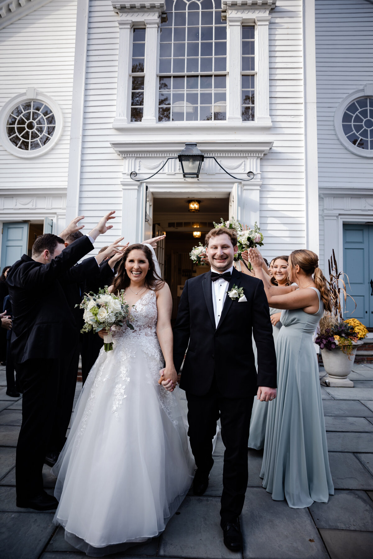 A Bride and Groom exit a church on their wedding day.