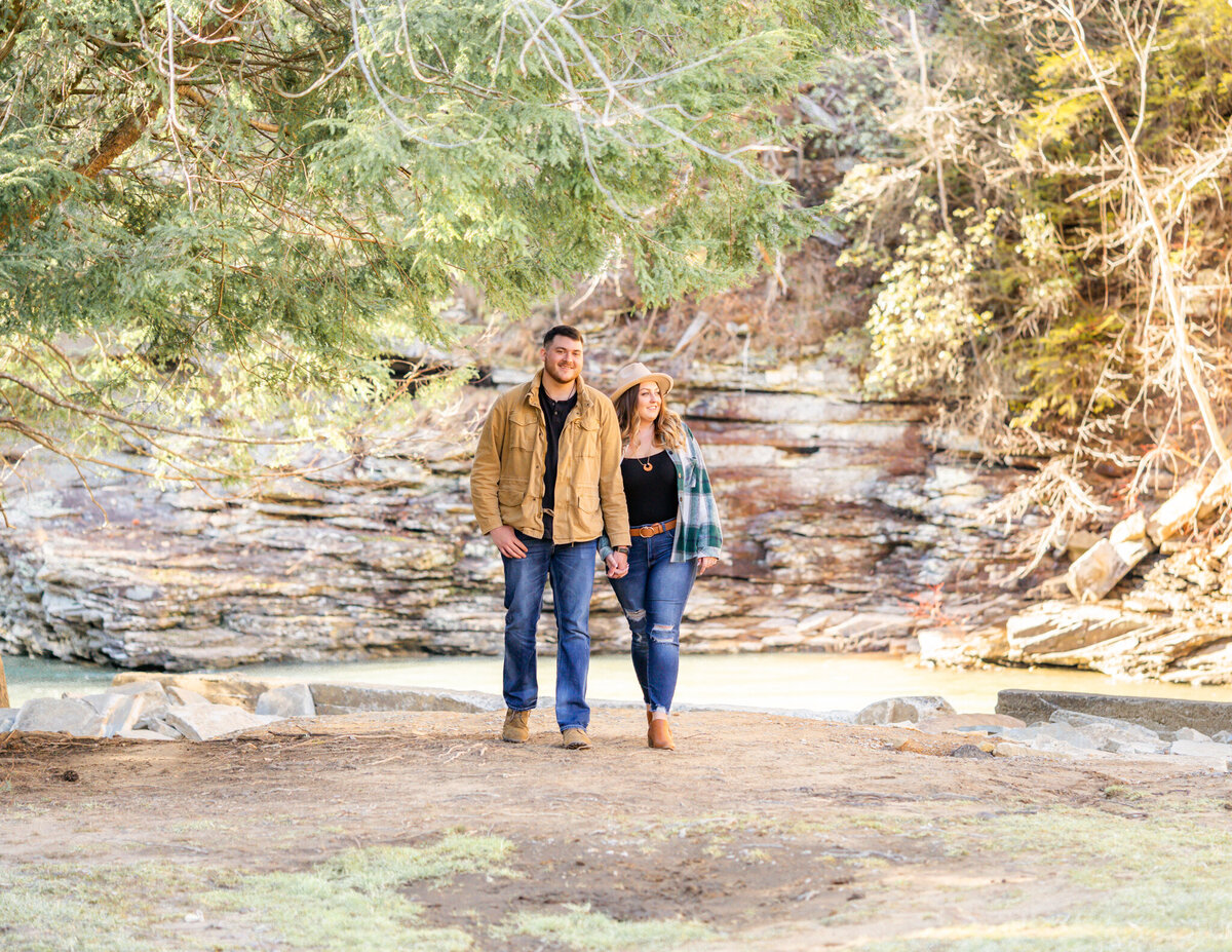 Future husband and wife walking close to water fall at fall creek falls state park
