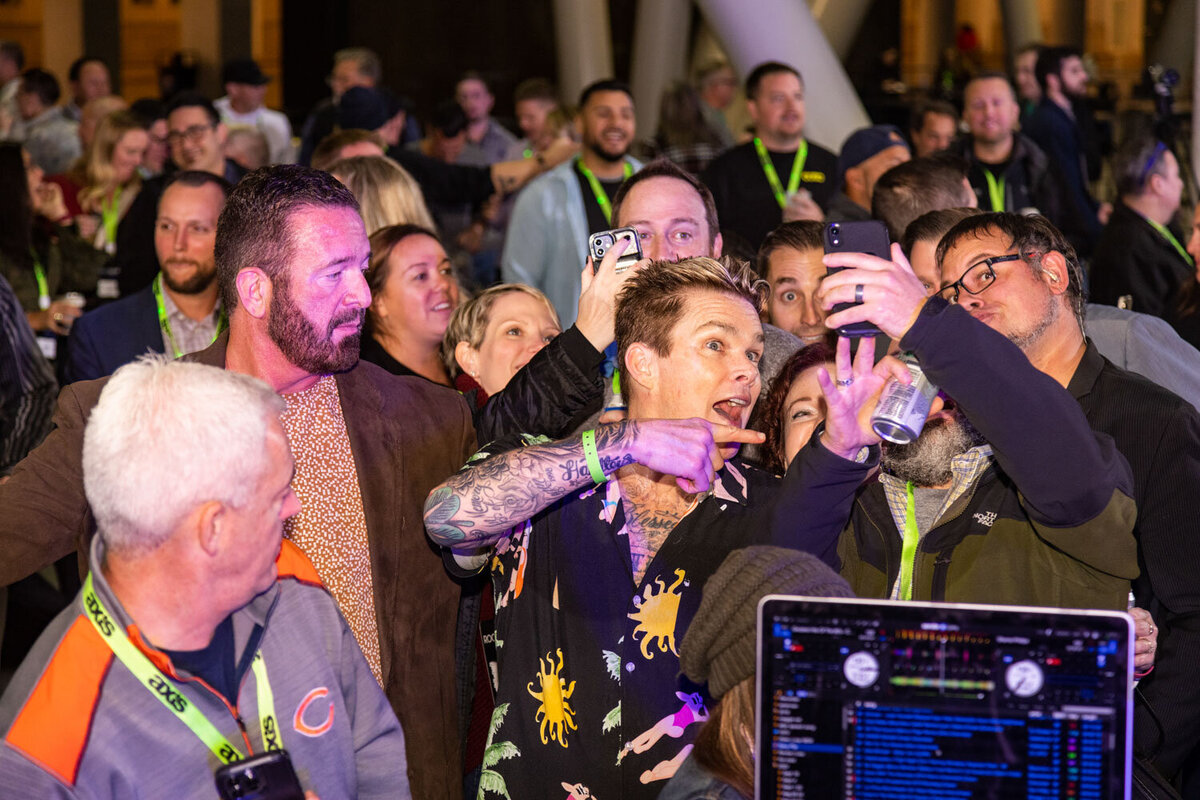 Crowd of people taking selfies at a lively party