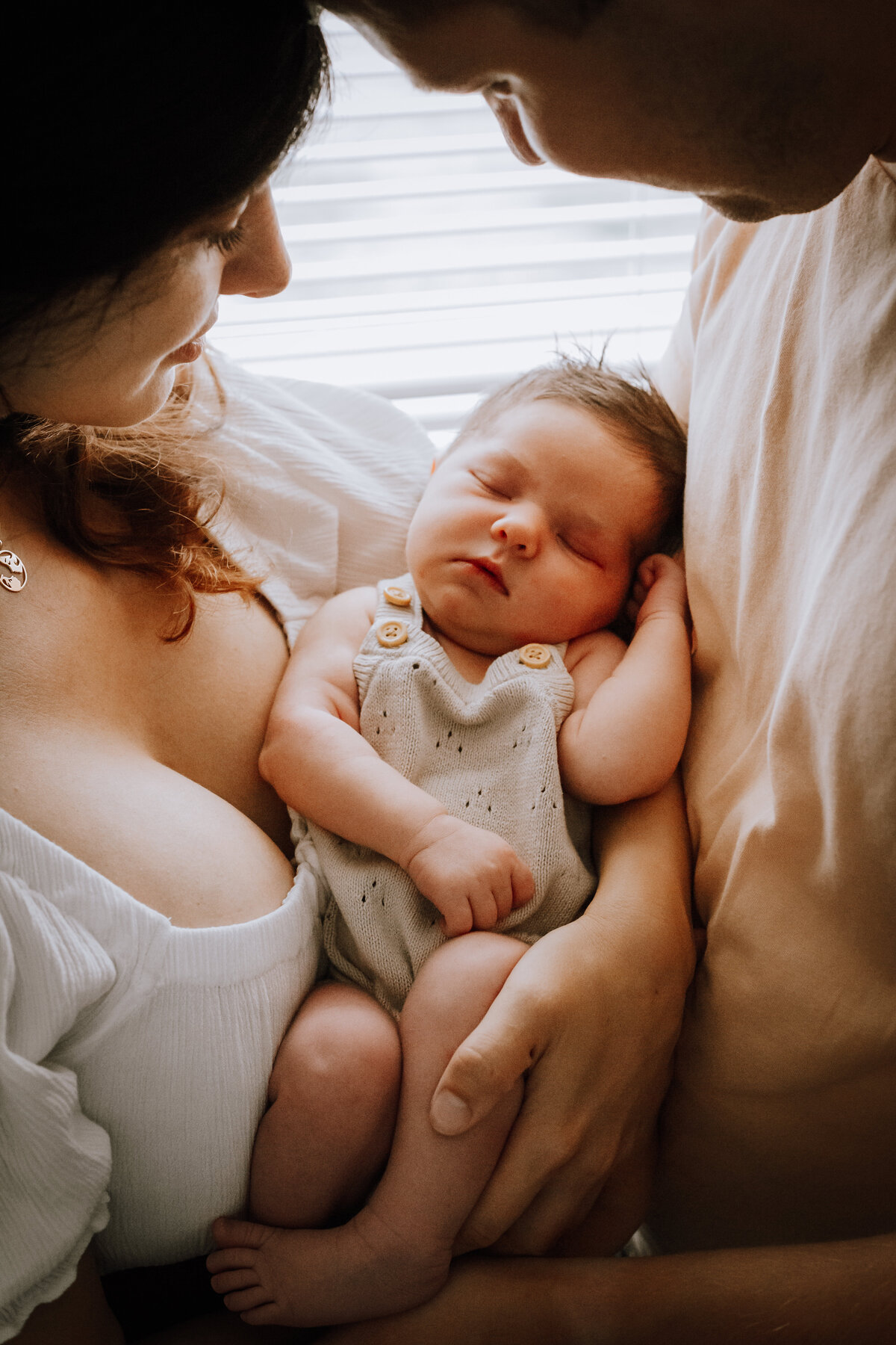 Mom & Dad holding their precious newborn