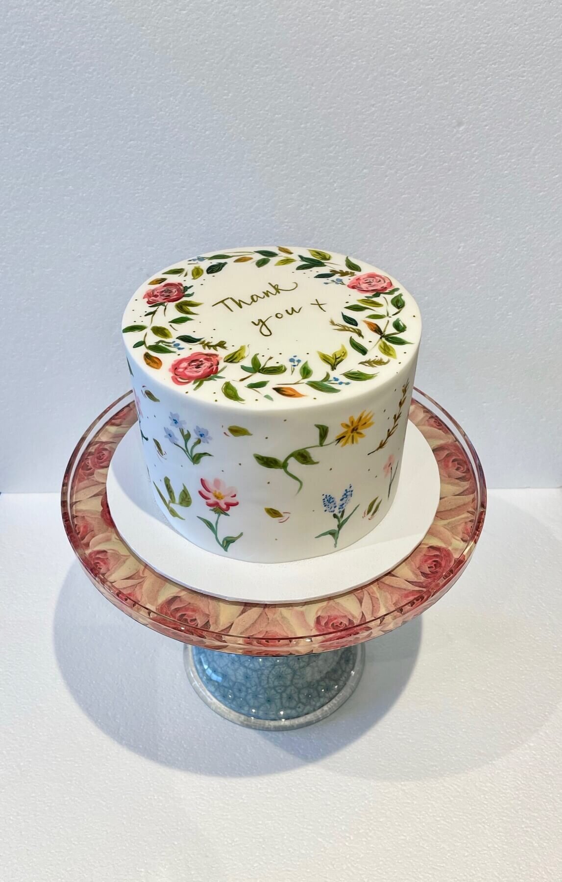 An elegant hand painted Thank You cake with hand painted flowers