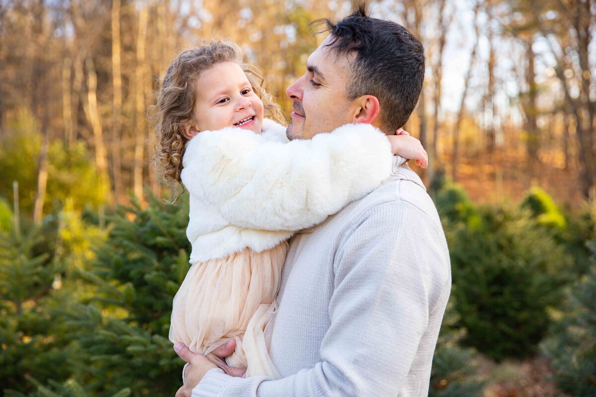 father and daughter on Christmas tree farm