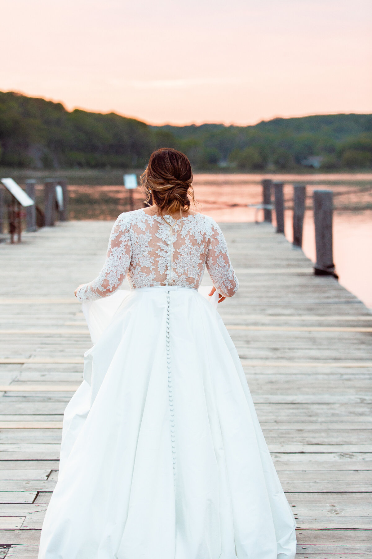 Bride walks down the dock at the Mystic Seaport.