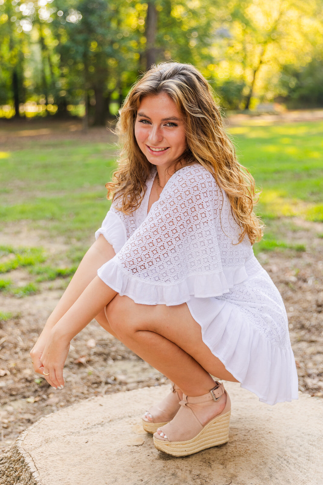 High school senior girl  sitting on her talon   hands together durong her summer portraits by Laure Photography