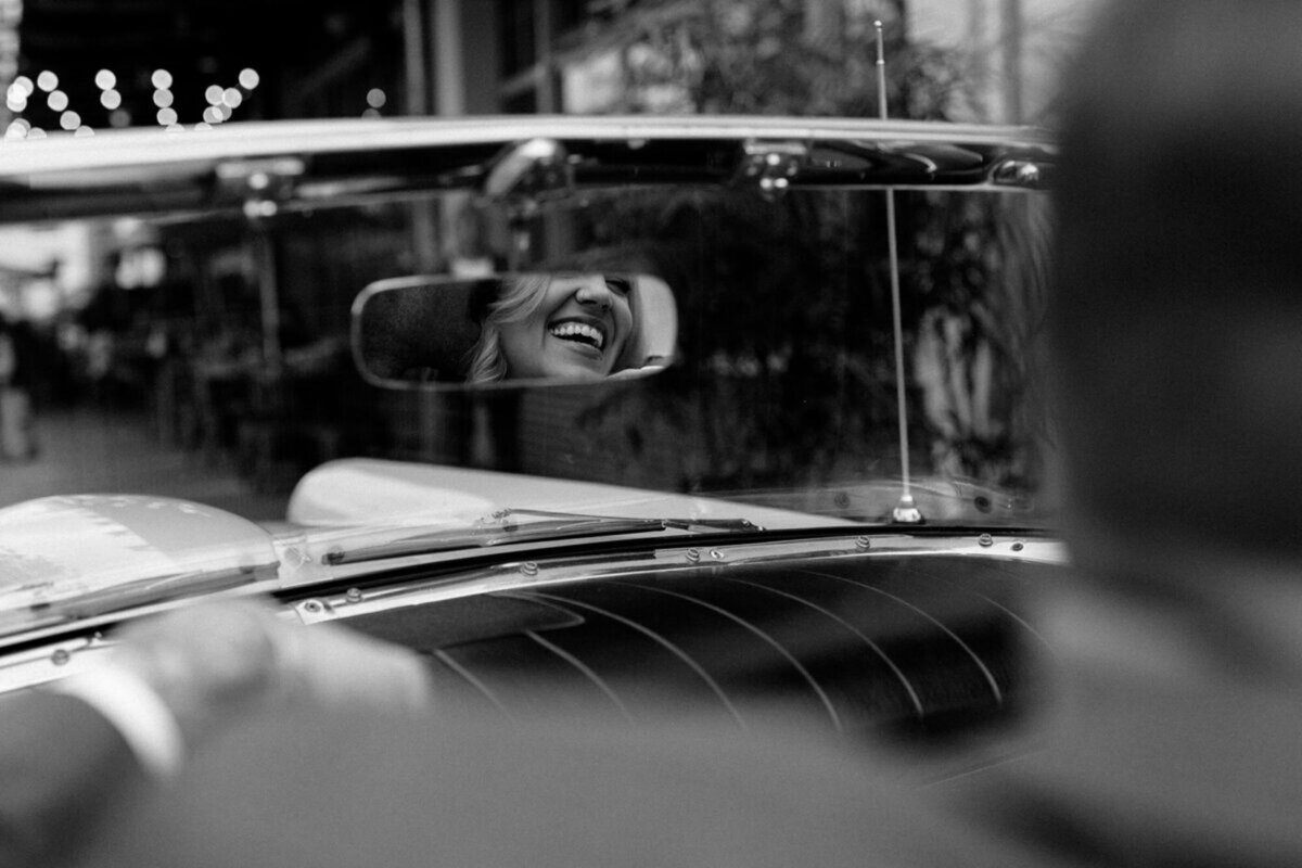 orlando engagement photography with woman's face in mirror of classic car