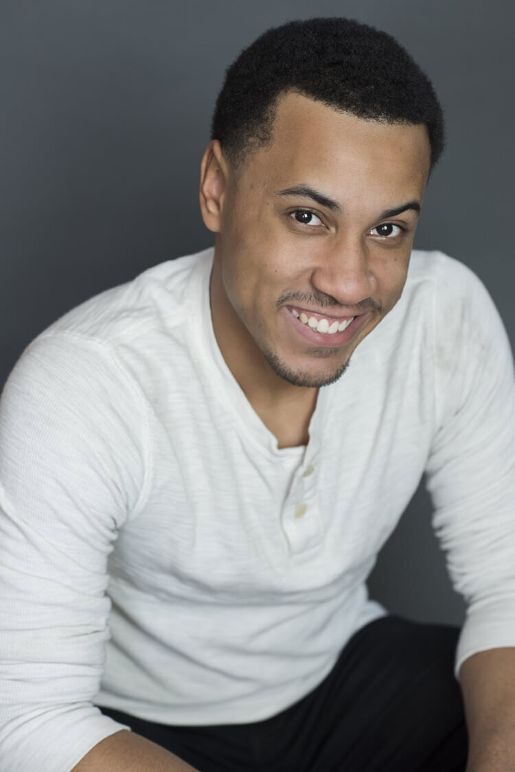 A man sitting while looking up and smiling