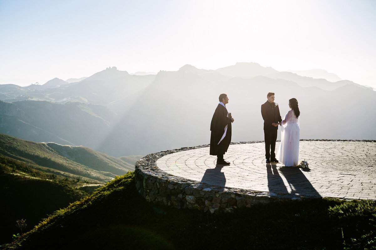 couple elopes in front of mountains
