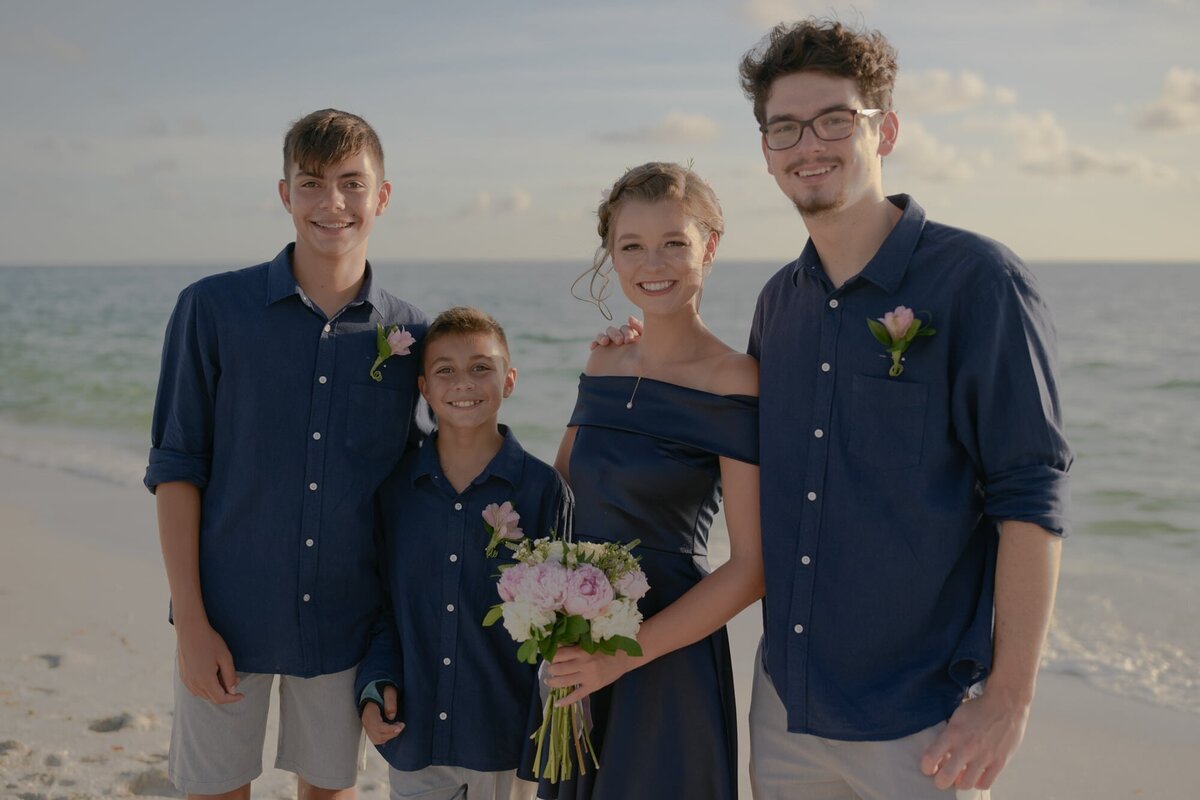 Siblings at beach wedding