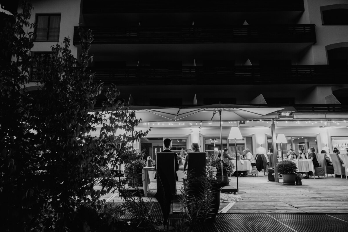 Black and white photo of guests dining outside