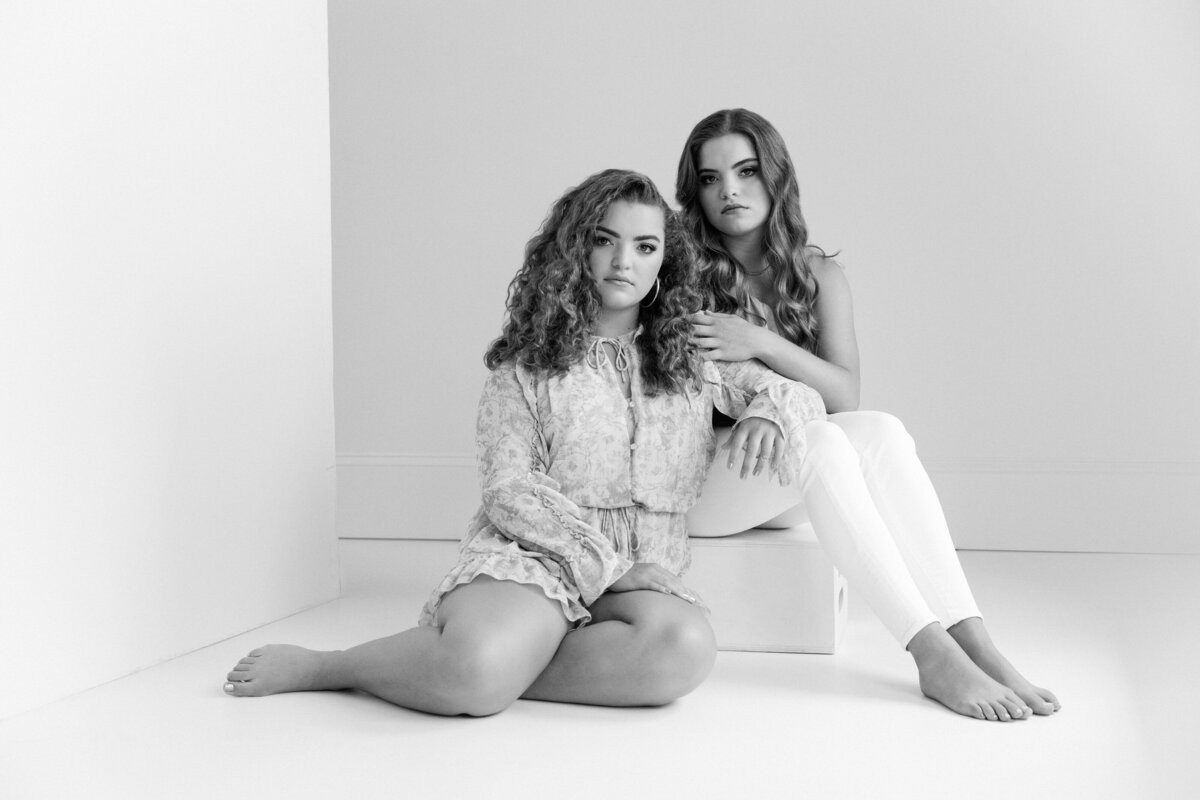 Two girls sitting together in a studio