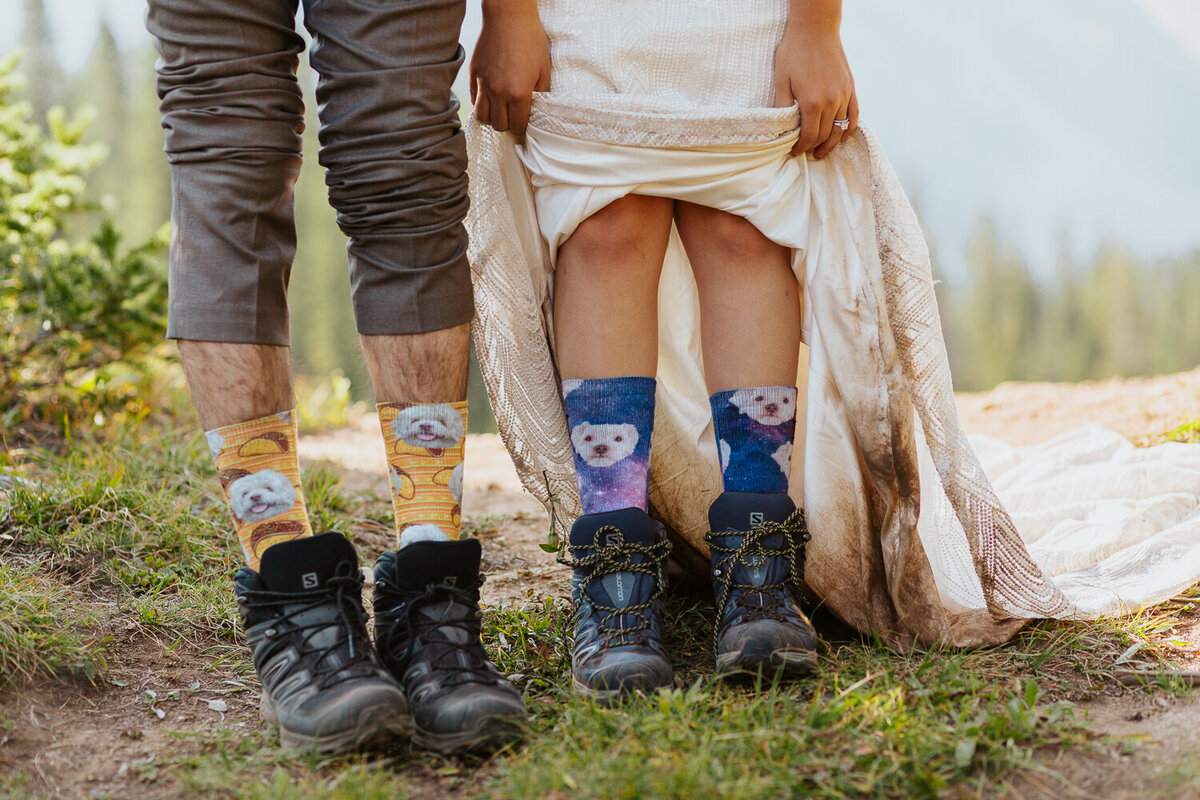 A couple shows off their hiking boots and socks during their elopement in Crested Butte.