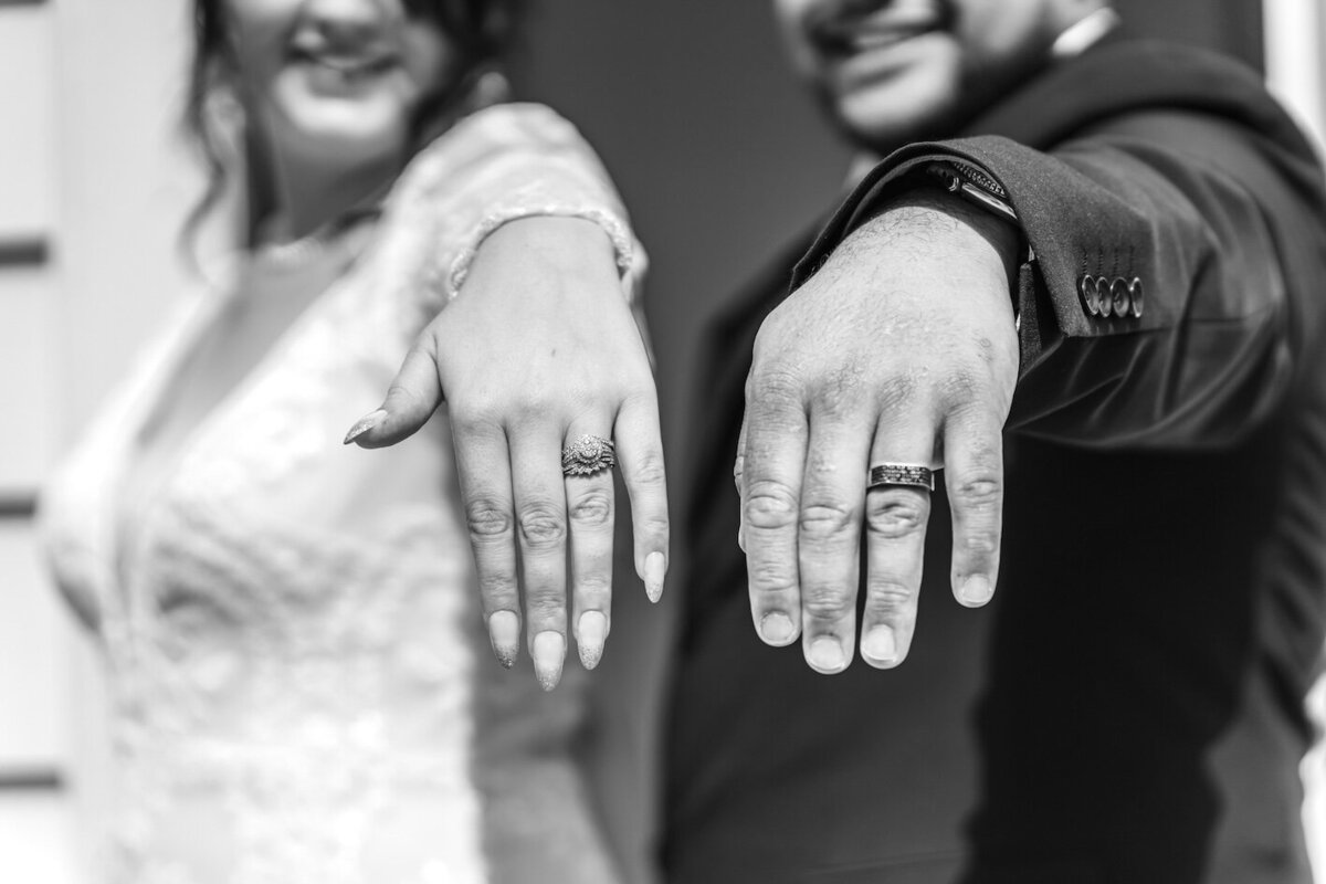 Stylish bride and groom with sparkling wine spray in urban setting