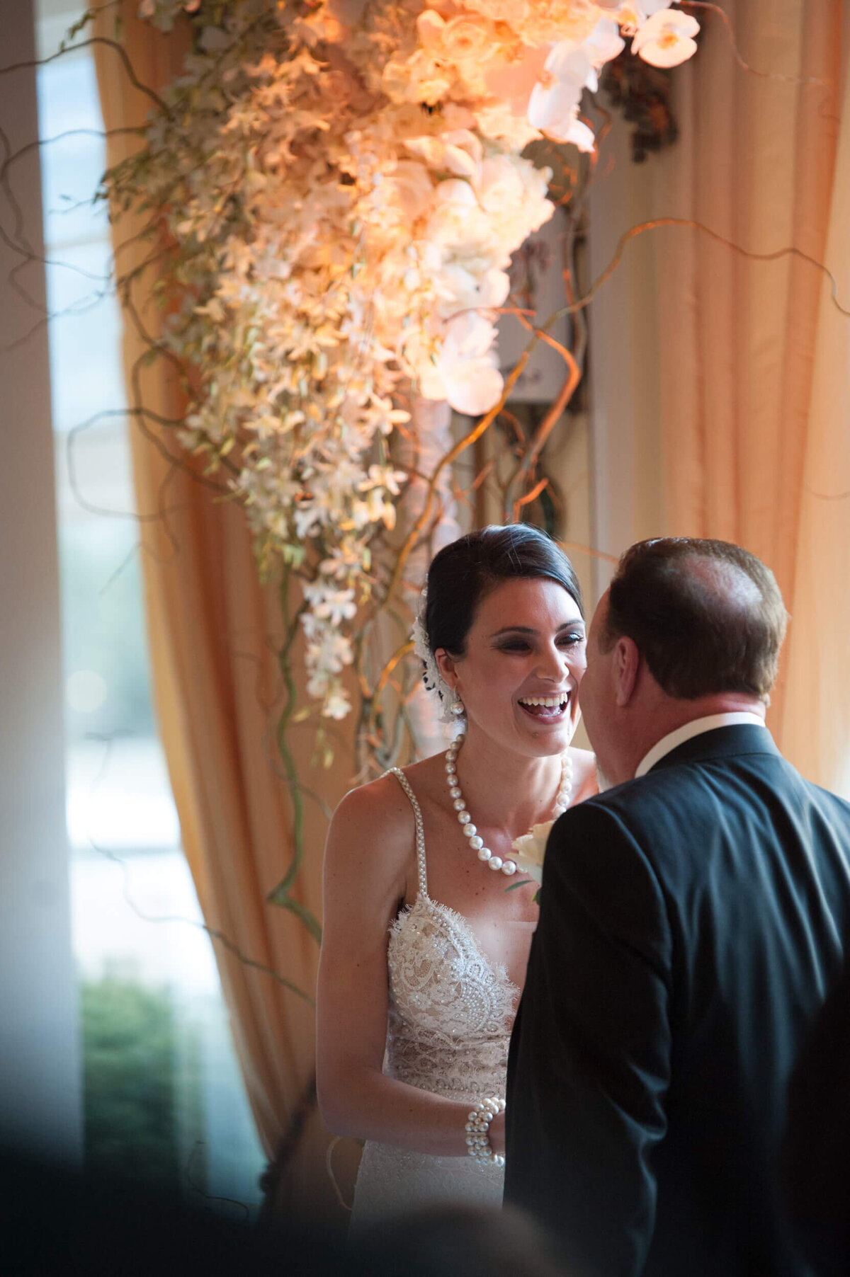 Bride smiles with delight as she looks at her groom
