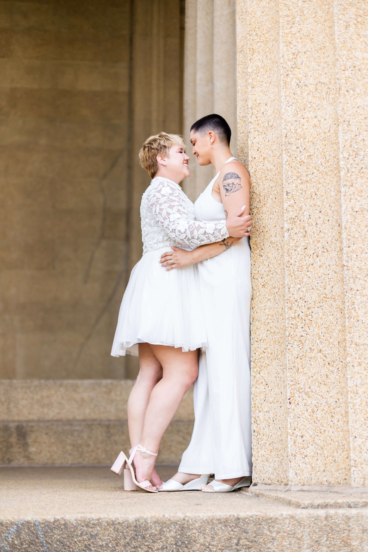 Gay couple in white outfits at LGTBQ wedding in Centennial Park, Nashville,TN
