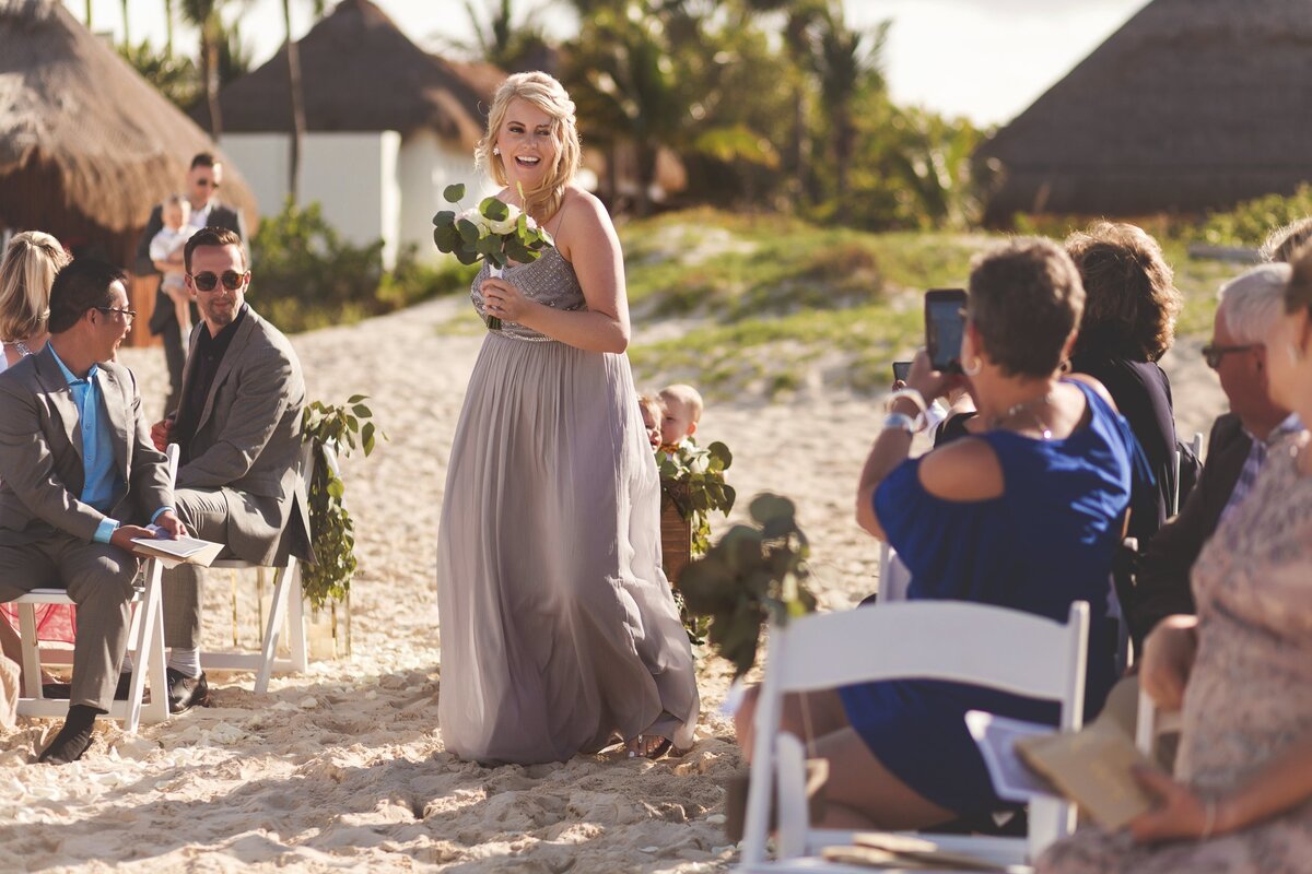 Bridesmaid bringing waggon with flower girl before wedding in Cancun