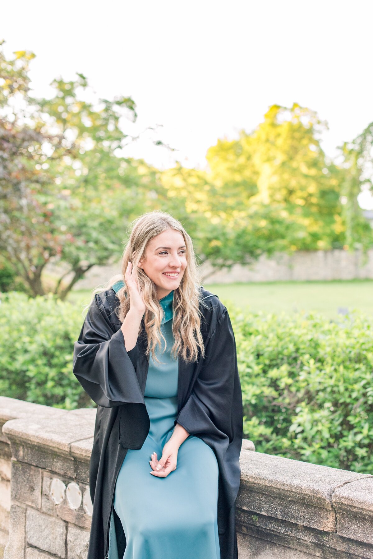 female sitting on ledge graduation georgetown