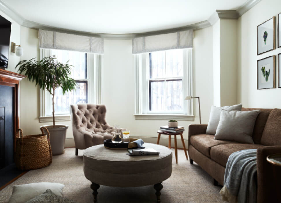 Brownstone Renovation features a new family room fireplace, traditional furniture, and custom window treatments by a Boston interior decorator.