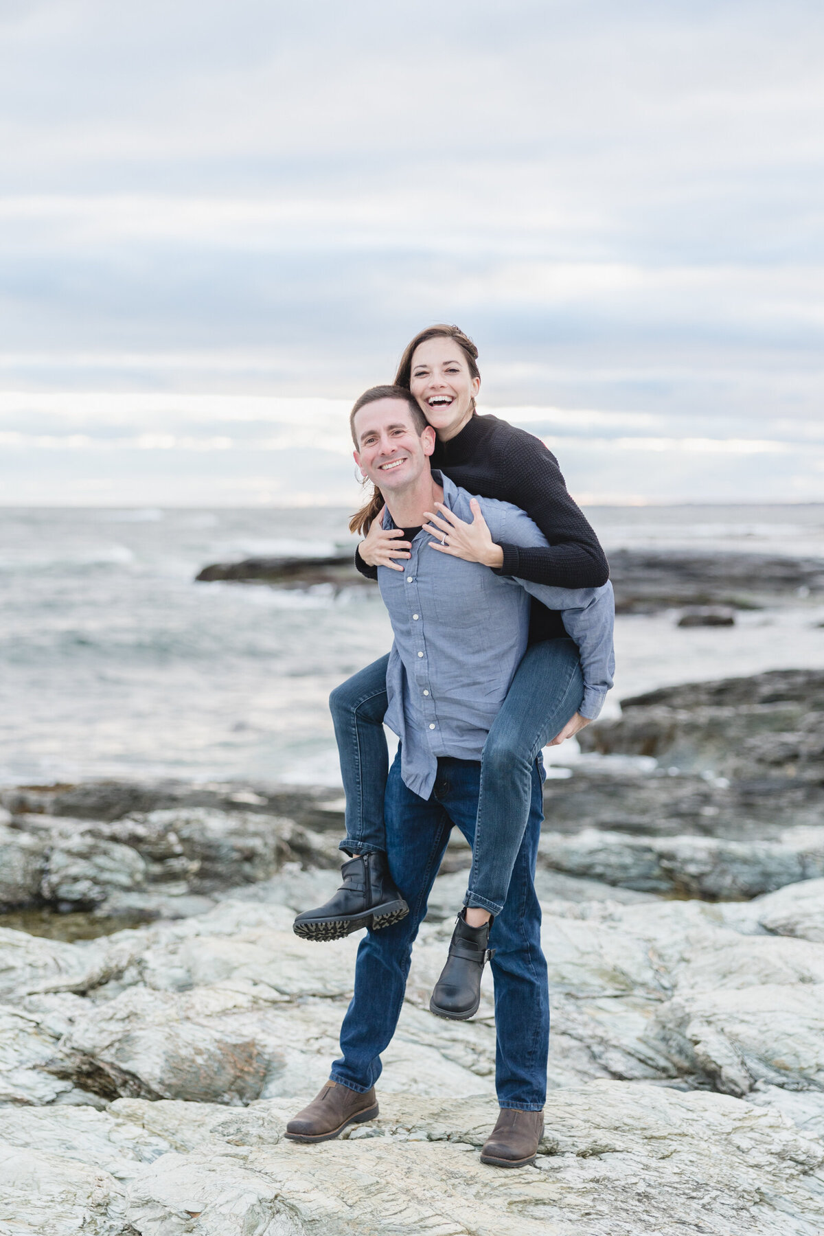 Engaged couple has fun during their engagement shoot at Brenton Point Park