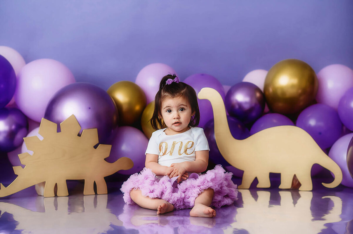 Baby poses for portraits during Cake Smash Photos in Asheville, NC.